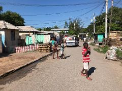 07B People, vans, kids and houses on 2nd Street scene Trench Town Kingston Jamaica